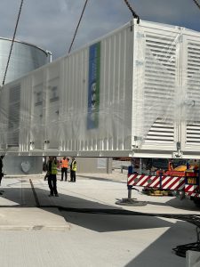 Generator suspended in the air by a crane
